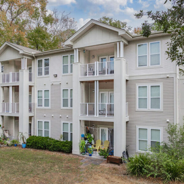 Three-story townhouse with light blue siding and white trim.