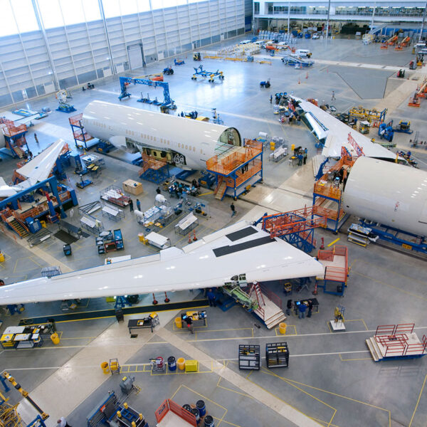 An airplane being constructed inside of a Boeing warehouse.