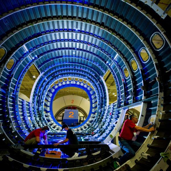Three people work on the interior of an aircraft at the Boeing facility in Charleston, SC.