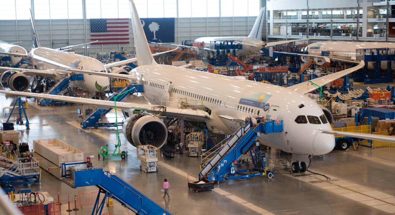 Four passenger airplanes sit in a hangar in the Charleston region.