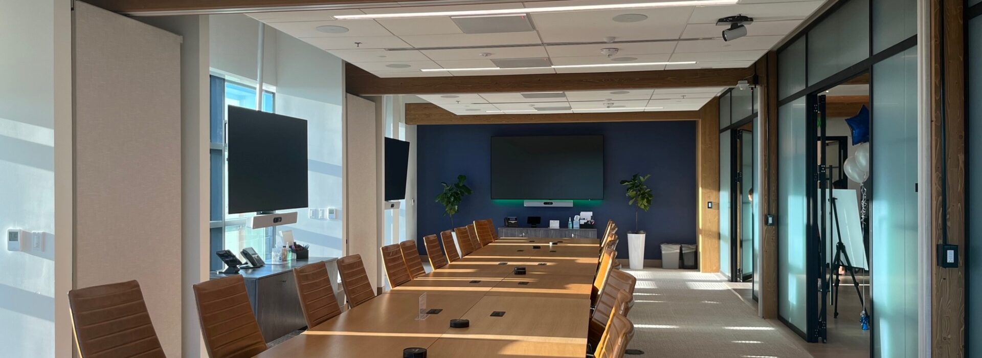 The interior of a modern corporate boardroom during the day.