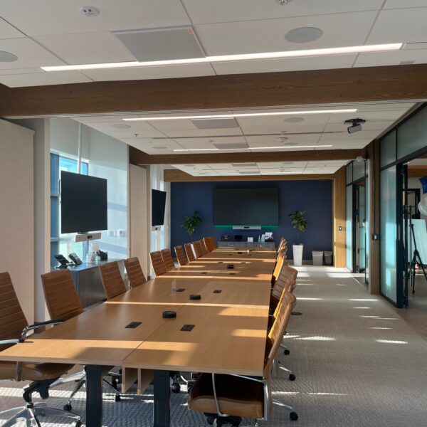 The interior of a modern corporate boardroom during the day.