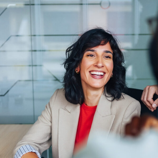 A business woman smiles at a colleague.